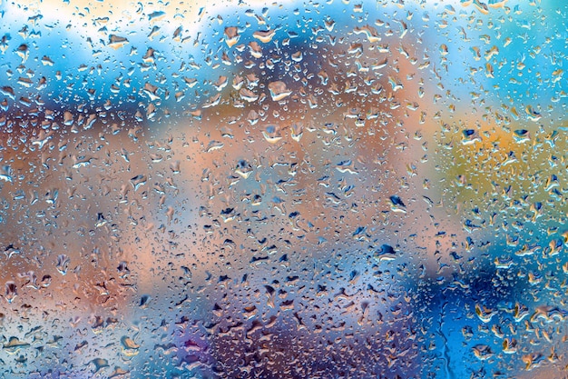 Drops Of Rain On Glass window Background Street Bokeh Out Of Focus Autumn Abstract Backdrop rainy days rain drops on window surface