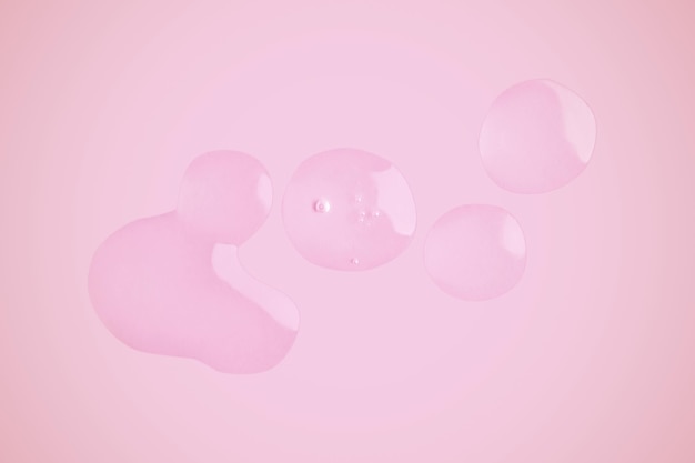 Drops of transparent gel on a pink background