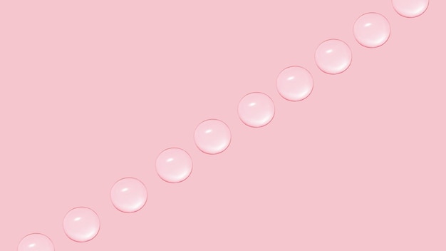 Drops of transparent gel or water in a row On a pink background