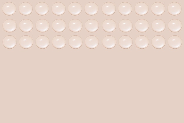 Drops of transparent gel or water in rows On a beige background