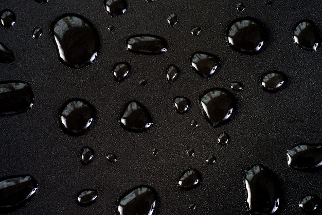 Photo drops of water on a black matte surface