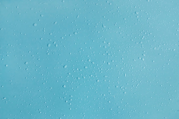 Drops of water on a blue surface. 