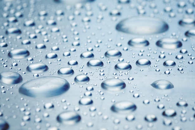 Drops of water on a light surface close.Macro water drop.