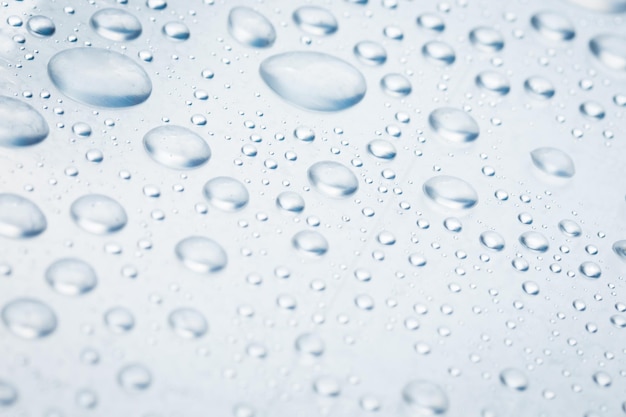 Drops of water on a light surface close.Macro water drop.