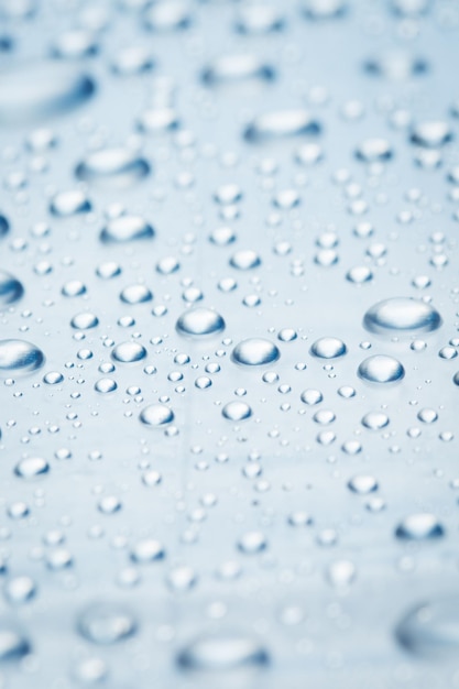 Drops of water on a light surface close.Macro water drop.