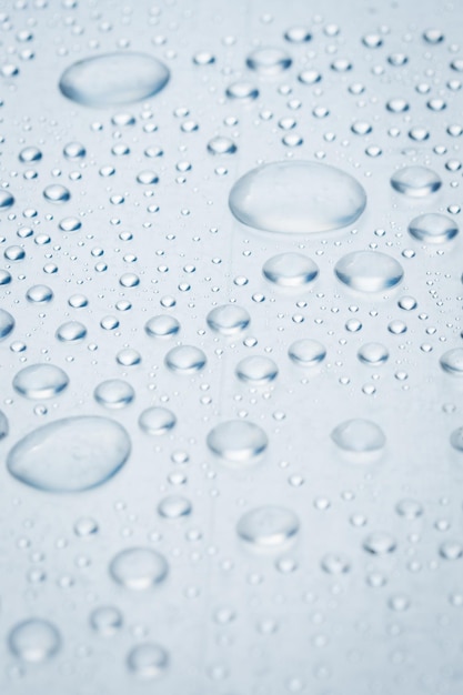 Drops of water on a light surface close.Macro water drop.