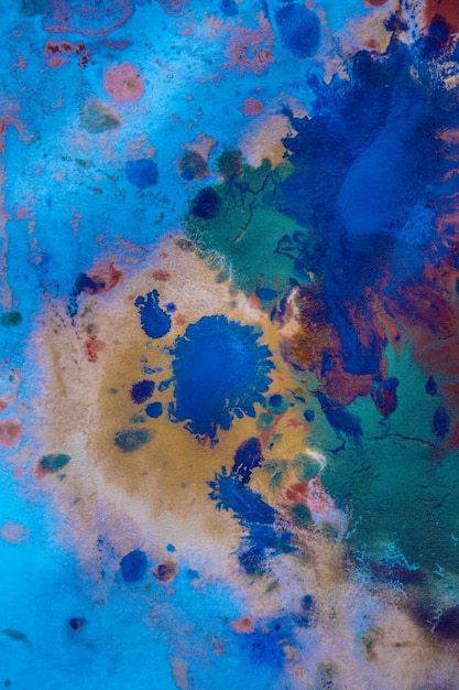 Drops with streaks of different colors paint are mixed and absorbed