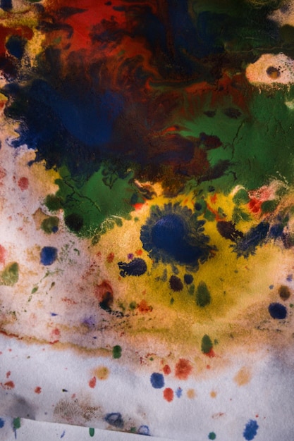 Drops with streaks of different colors paint are mixed and absorbed