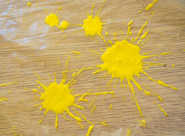 Photo drops of yellow paint on the floor after renovation