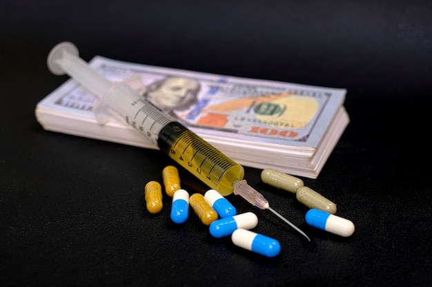 Drug medicine syringe and money banknote on the black background