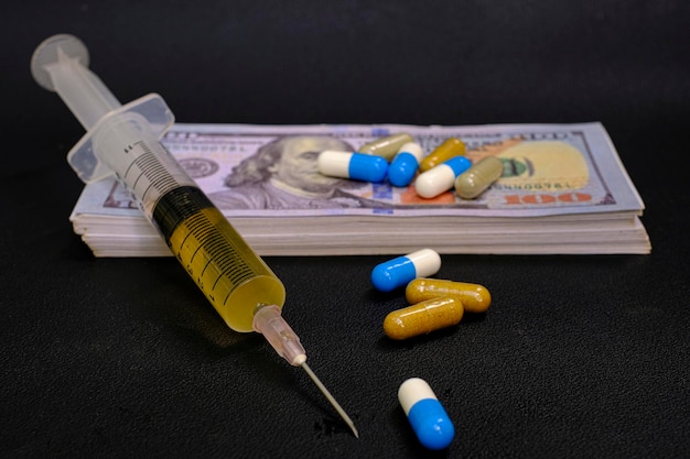 Drug medicine syringe and money banknote on the black background