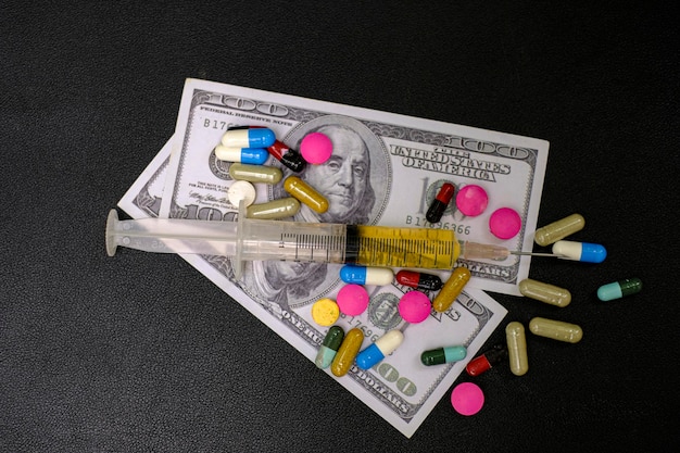 Drug medicine syringe and money banknote on the black background