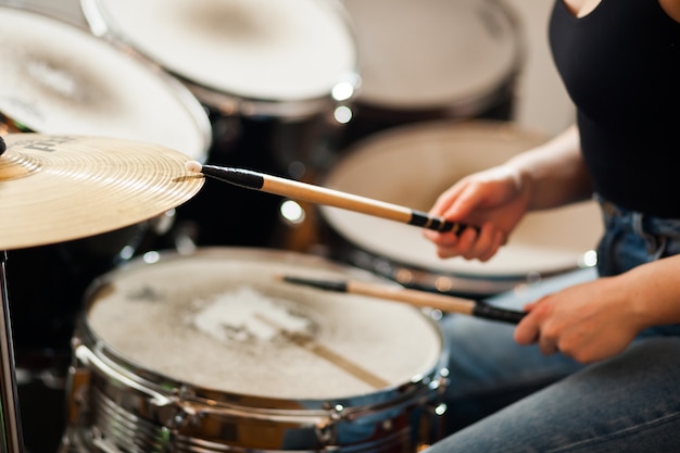 The drummer plays the drums.