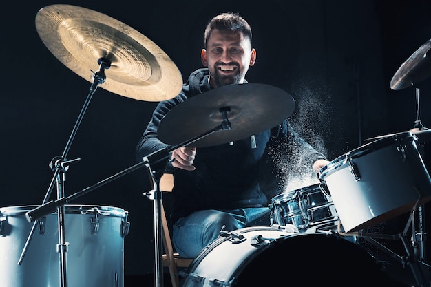 Drummer rehearsing on drums before rock concert Man recording music on drum set