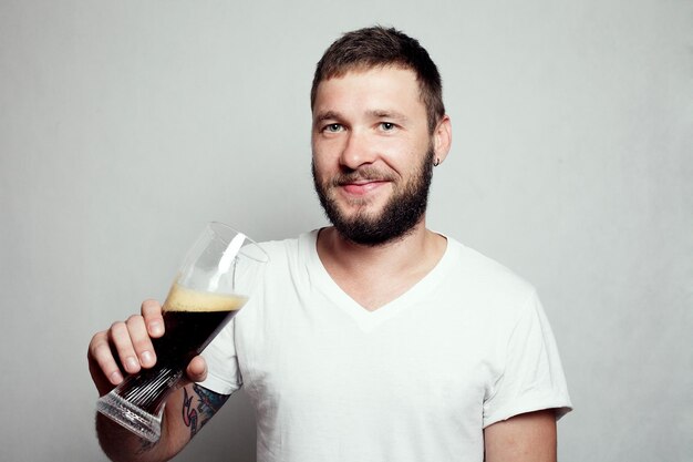 Drunk tattooed bearded man in a white Tshirt