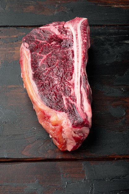 Dry aged club steak set, on old dark  wooden table background