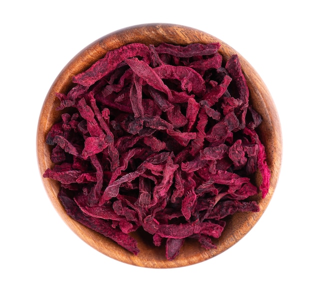 Dry beetroot in wooden bowl isolated on the white background Chopped dried beet Top view