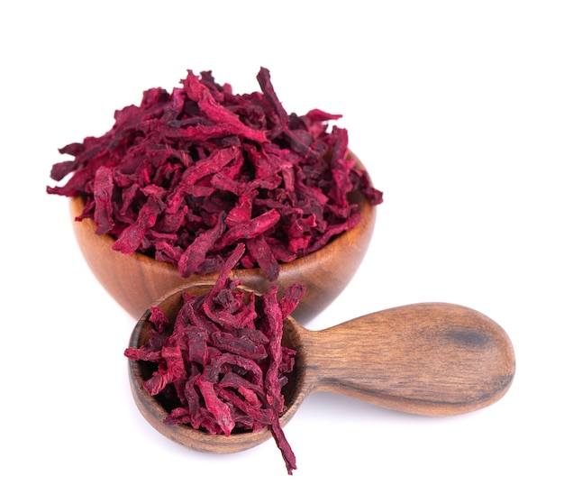 Dry beetroot in wooden bowl and spoon isolated on the white background Chopped dried beet