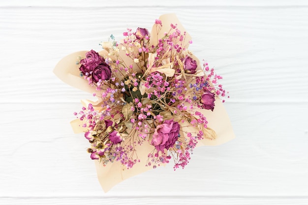 Dry bouqquet on white wood background Top view