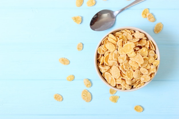 Dry breakfast in a plate on a colored background top view cereal