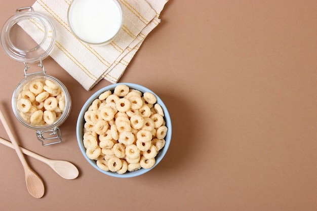 Dry breakfast in a plate on a colored background top view cereal