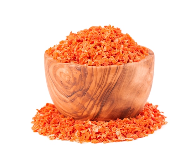 Dry carrot in olive bowl, isolated on the white background. Chopped dried carrot. Spices and herbs.