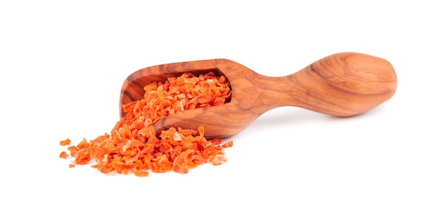 Dry carrot in olive scoop, isolated on the white background. Chopped dried carrot. Spices and herbs.