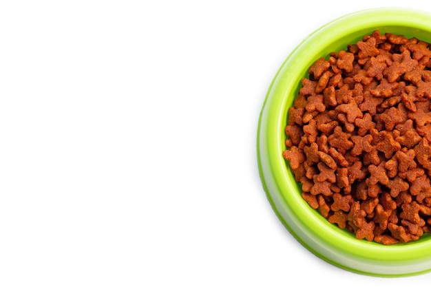 Dry cat food  in green bowl on white