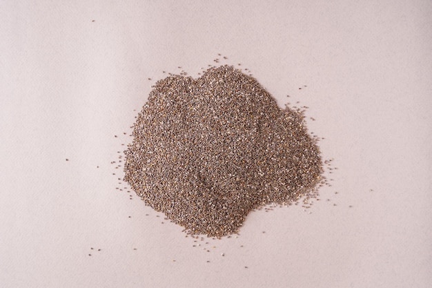 Dry chia seeds heap on white background top view