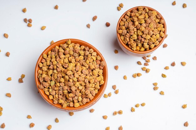 Dry chickpea in bowl on white background.