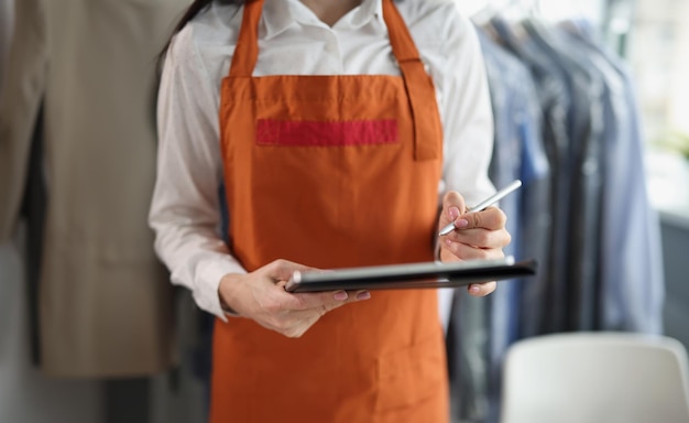 Dry cleaning company worker in uniform take order high quality service