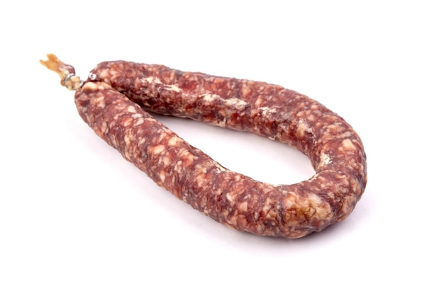 Dry cured pork sausage ring isolated on white background