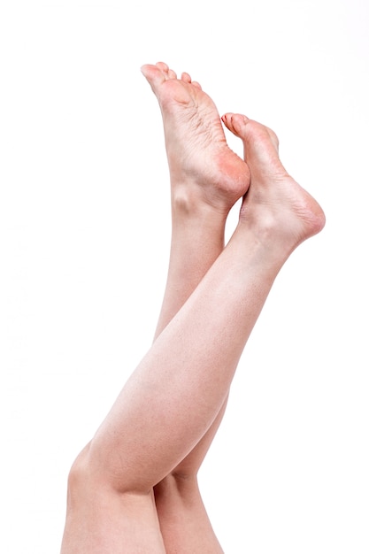 Dry dehydrated skin on the heels of female feet with calluses