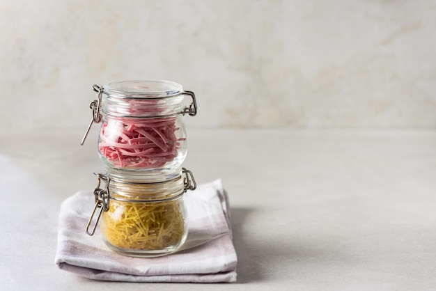 Dry Eggs and Beet Noodle Pasta in a Glass Jar Homemade Noodle Copy Space