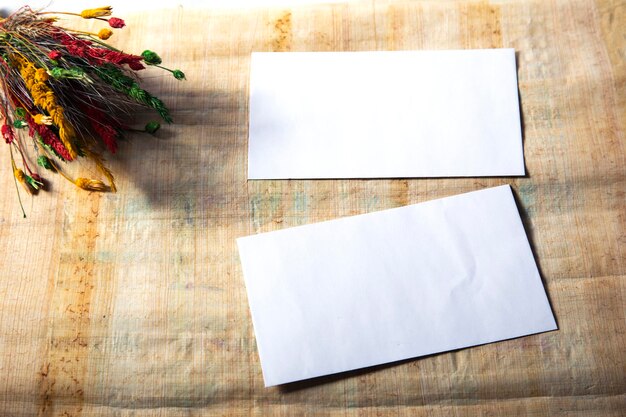 Dry flower with blank notebook on old wooden table Vintage tone