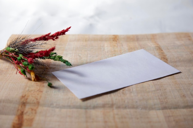 Dry flower with blank notebook on old wooden table Vintage tone