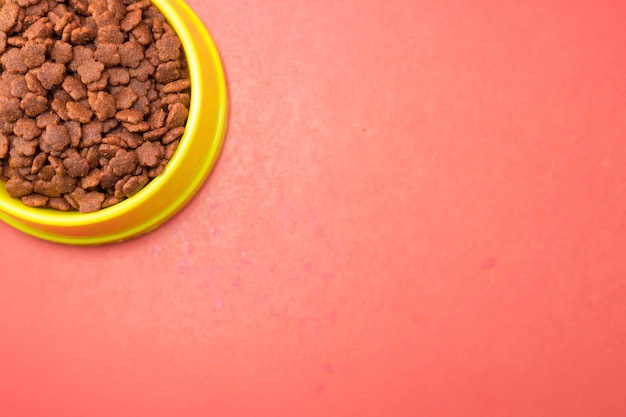 Photo dry food in bowls for pet on red background