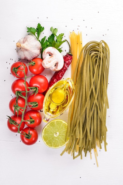 Dry green Pasta with spinach and vegetables On a wooden background Italian Traditional Cuisine Top view Copy space