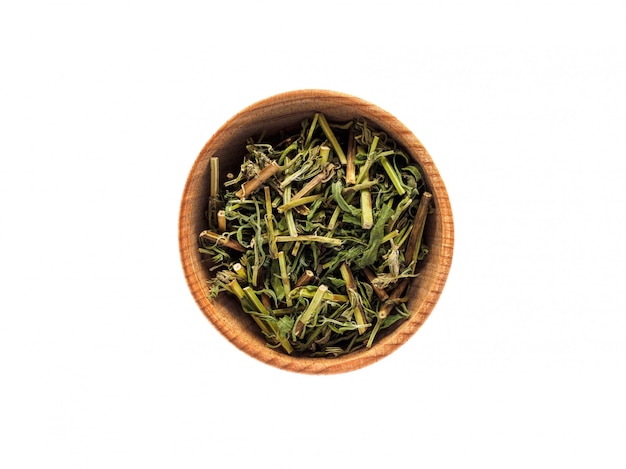 Dry Hyssopus officinalis in wooden cup on white table