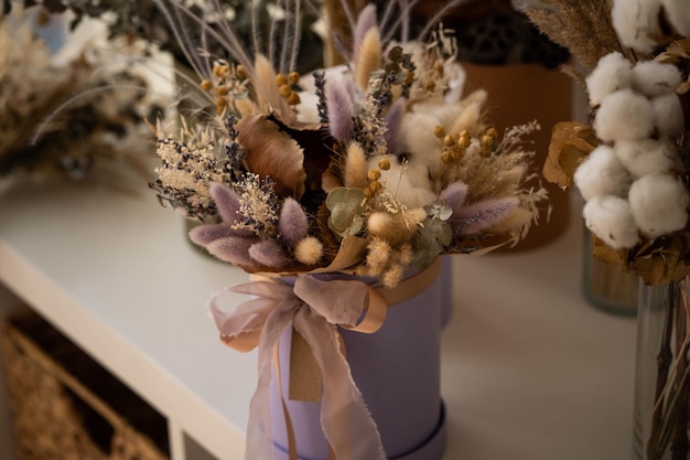 Dry inflorescences are collected in a beautiful composition in a hat box, incredible art