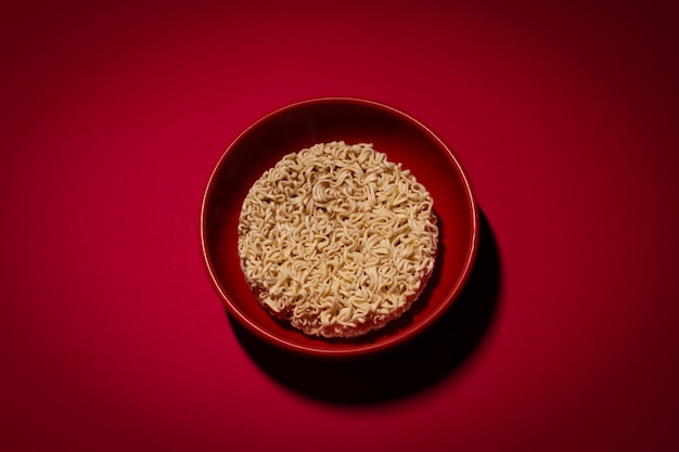 Dry instant noodles on the red background