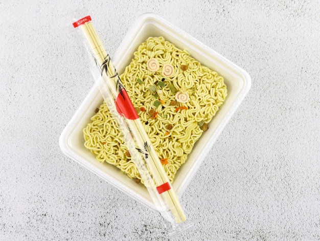 Dry instant noodles in a tray with spices, dried vegetables and soy meat. Fast food dry vermicelli