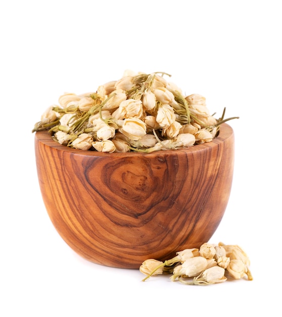 Dry jasmine flowers in wooden bowl isolated on white background Jasmine flowers tea Herbal tea