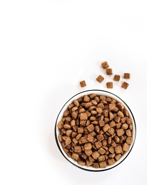 Dry pet food in a white ceramic bowl