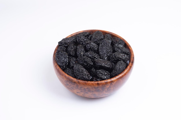 Dry Prunes in a wooden bowl White background