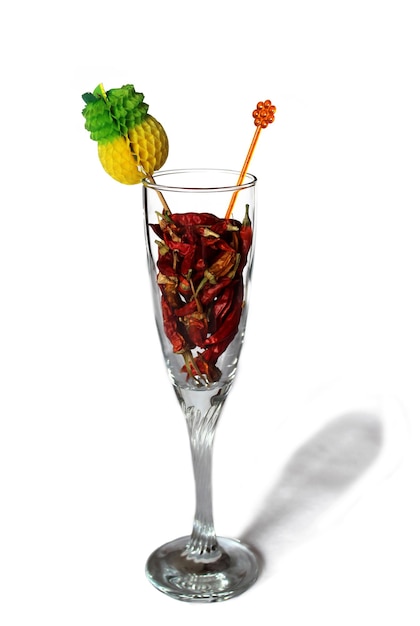 Dry red chili pepper in glass on a white background