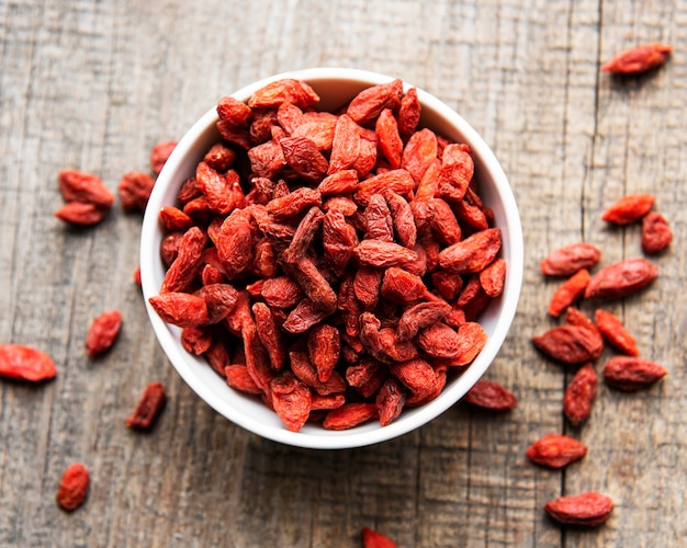 Dry red goji berries for a healthy diet on a old wooden background