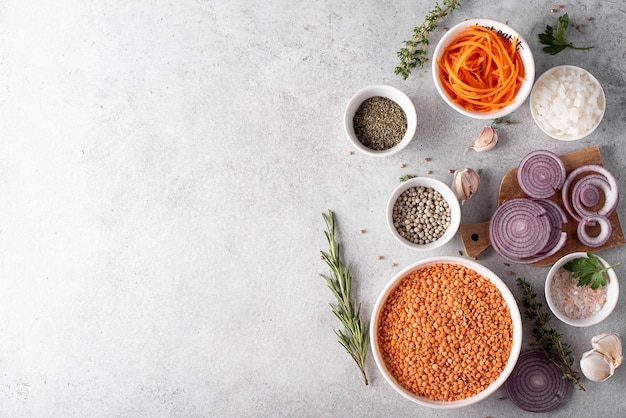 Dry red lentils in a white bowl with onions and spices