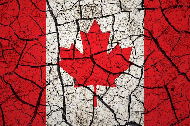 Dry soil pattern on the flag of Canada. Country with drought concept. Water problem. Dry cracked