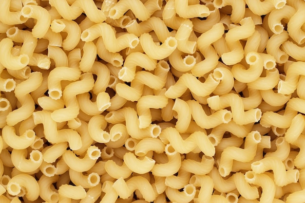 Dry uncooked cellentani pasta texture background